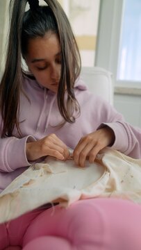 Young woman guiding precise needlecraft techniques attentively