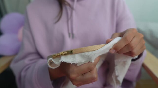 Intricate work of mending fabric pouch with precision and patience