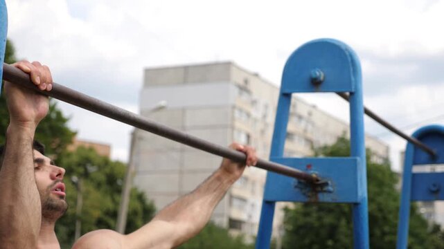 Sportsman performing pull-ups on blue outdoor bar, showcasing strength and determination, with urban background and dynamic motion captured in sequential frames of workout progression