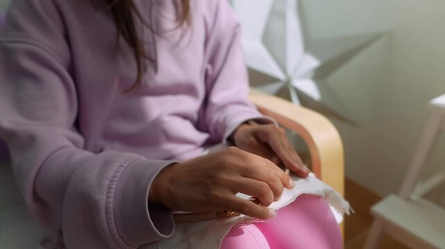 Enthusiastic young woman crafting fabric within her living space