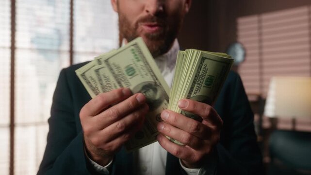 Cropped view unknown Caucasian business man excited counting money rejoice feeling excitement triumph emotion unrecognizable bearded businessman euphoric count cash dollars banknotes capital budget
