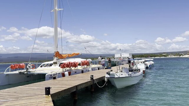 Static shot of docked boats and a catamaran at Cabo Rojo marina