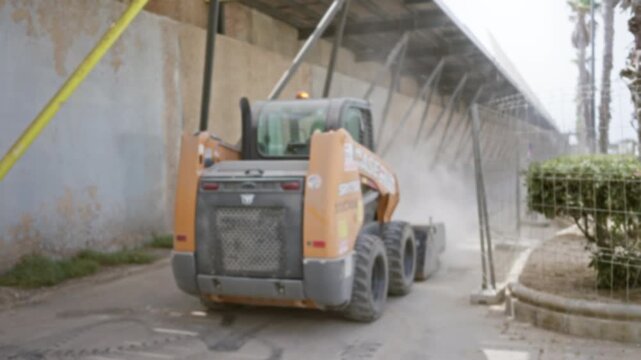 Construction site with blurred bokeh and defocused industrial loader underpass outdoor; background backplate copyspace template.