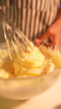 Energetic kitchen worker quickly preparing mixture with enthusiasm