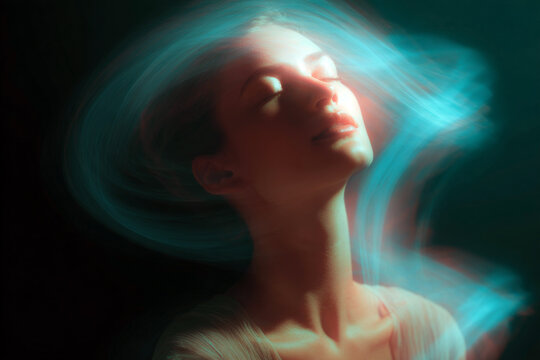 Woman exhaling shimmering spirals of light with teal motion blur for meditation background and breathwork poster design