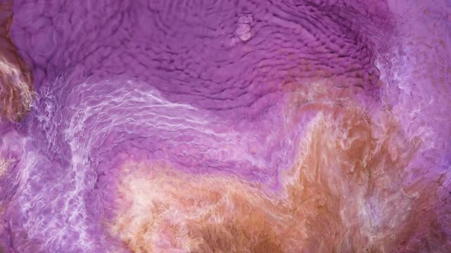 Creative use of alcohol ink results in fluid patterns of purple and orange