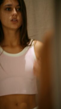 Person carefully inspecting attire showing serene confidence and softness