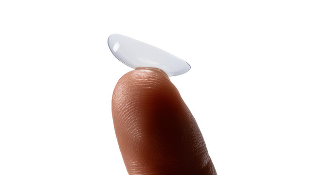 Isolated transparent contact lens resting on a person's fingertip, ready for eye insertion procedure