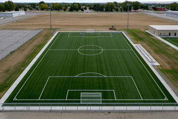 Fototapeta premium Daytime green soccer field at complex