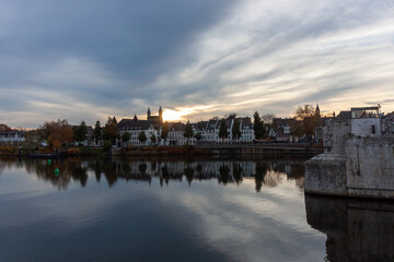 Fototapeta premium Beautiful sunset over the historic city of Maastricht with reflections