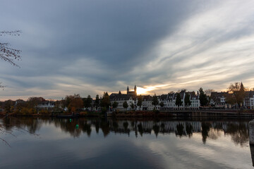 Fototapeta premium Beautiful sunset over the historic city of Maastricht with reflections