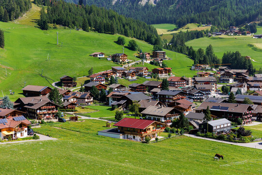 Scenic aerial alpine view austrian mountain village Kals am Grossglockner valley green rural farmland meadow horse pasture background. Austria Alp osttirol National park nature. Summer hiking tourism