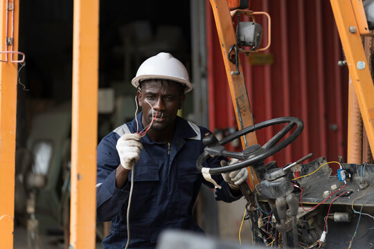 Automotive electrician or auto electrician checking, repair, maintenance operation automotive electrical systems