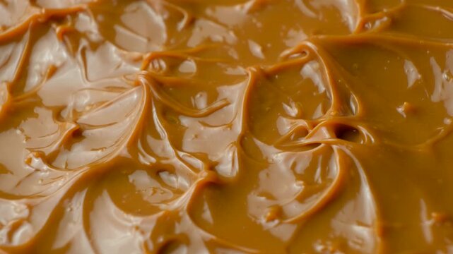 Boiled condensed milk texture or dulce de leche background.