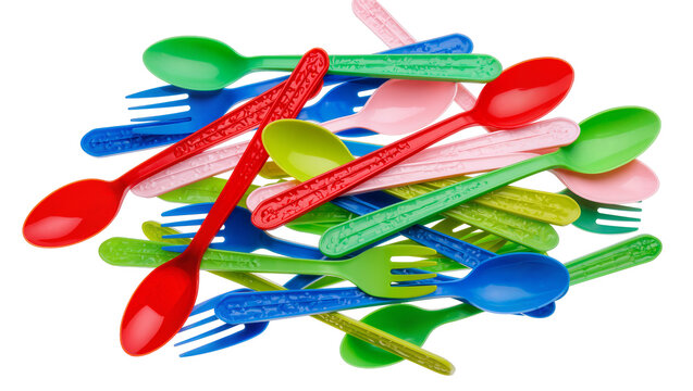 Isolated pile of colorful plastic disposable picnic forks and spoons arranged randomly