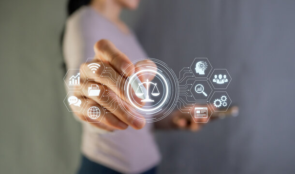 Woman touching digital law virtual interface with scales of justice icon, legal technology concept