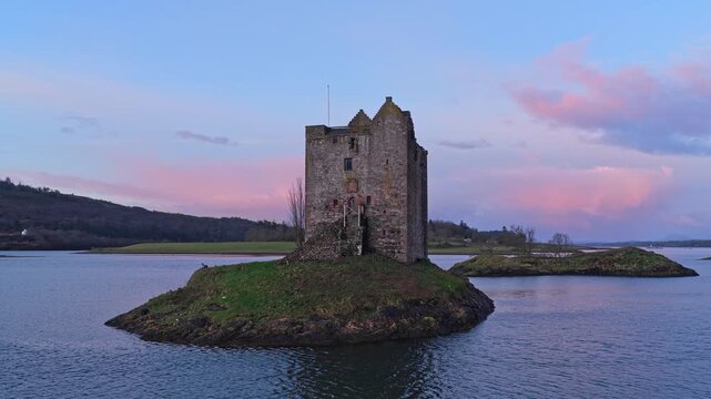 Aerial view of castle stalker during a colorful sunrise