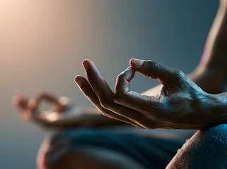 Meditation practice with hands in mudra position in a dimly lit space at twilight © alphaspirit