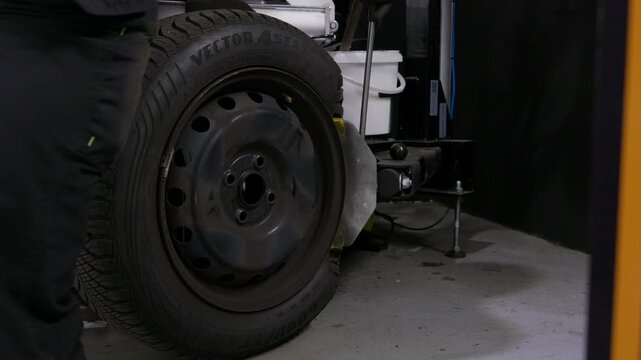 Tire Changer Machine Removing Tire from Wheel in Auto Workshop