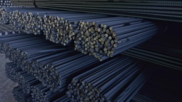 Bundles Of Steel Rebar Stacked In An Industrial Warehouse, Ready For Construction And Reinforcement Applications. - closeup shot