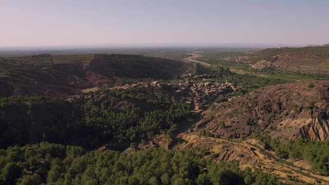 Setti Fatma area in the Ourika Valley, Al Haouz Province, Marrakesh Safi, Morocco, featuring Berber settlements, riparian vegetation and rugged High Atlas mountain terrain, drone aerial shot.