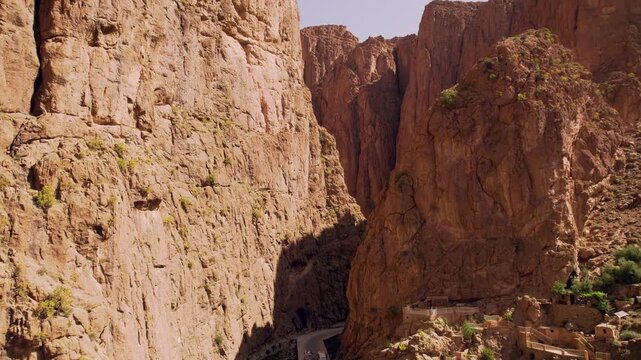 limestone canyon formations carved by the Todgha River within the eastern High Atlas Mountains, Todra Gorge near Tinghir, Dr&acirc;a Tafilalet, Morocco, drone pullback reveal shot.
