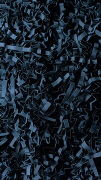 Black shredded paper slow rotation. Close-up of dense black cut and crumpled paper strips forming chaotic layered texture. Smooth continuous rotation reveals dynamic shifts in light and deep shadows.