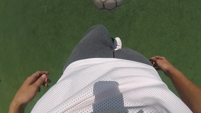 Football player in motion, skillfully dribbling a ball on vibrant green turf, showcasing dynamic footwork and athleticism, capturing the essence of the game in a seamless action sequence