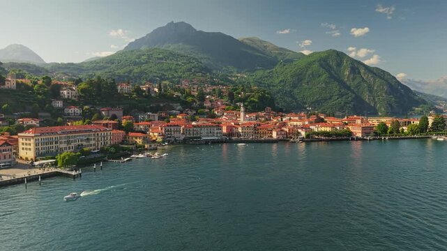 Scenic aerial view of Menaggio town on the shore of Lake Como, Italy. Beautiful resort destination features traditional houses and majestic mountains. Village of Menaggio, Como Lake