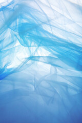Obraz premium Background, abstract blue mesh fabric creates soft wavy folds.