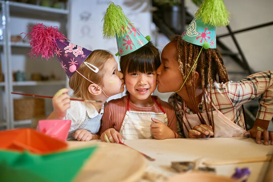 smiling children with birthday hats celebrate together at creative workshop.  Creative, hobby ,workshop  concept