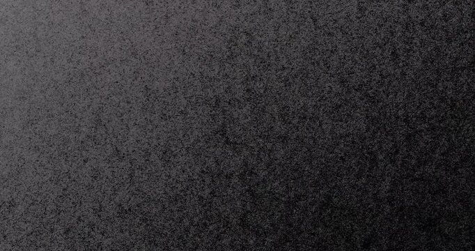 Dark Texture Abstract.  Smooth rotation of dark textured surface with fine grain pattern gently moving.
