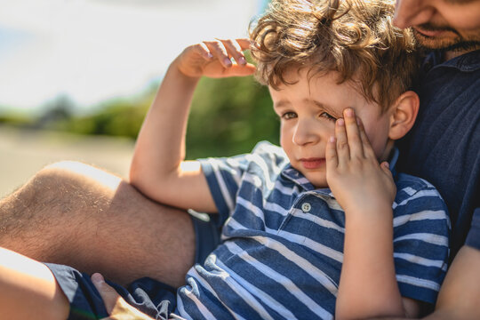 boy crying with his son outdoors in urban place