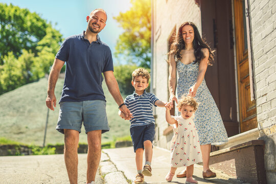 family of four people playing with childs outdoors in urban place