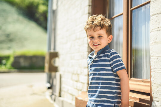 two years old child boy outside in urban summer season