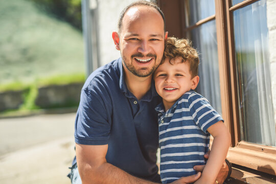 man playing with his son outdoors in urban place