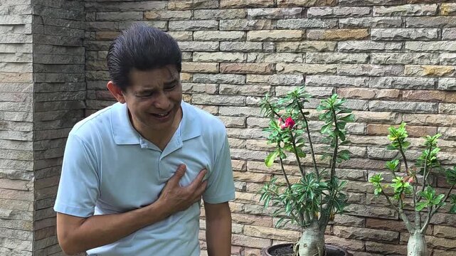 Old asian man suffering from heart attack or heart sickness condition