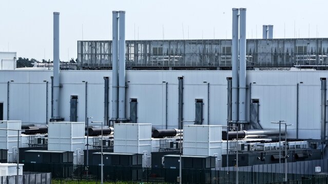 Aerial View of Large Data Center with Tall Exhaust Chimneys