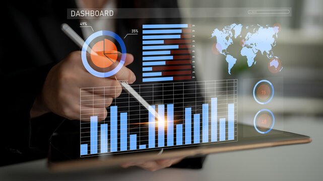 A professional uses a digital tablet to engage with interactive analytics and business data. This modern office setup emphasizes technology in decision-making processes. Impute