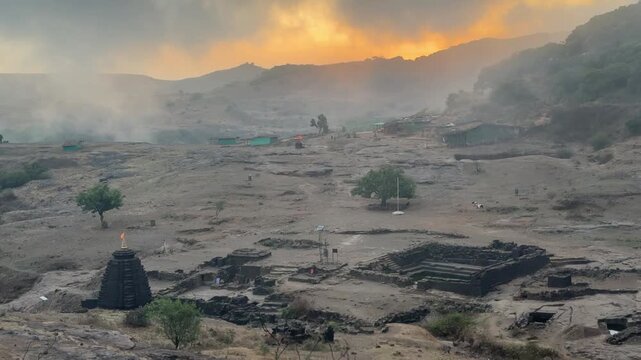 Amazing misty cloud movement during dawn at Harishchandragad temple complex. 
