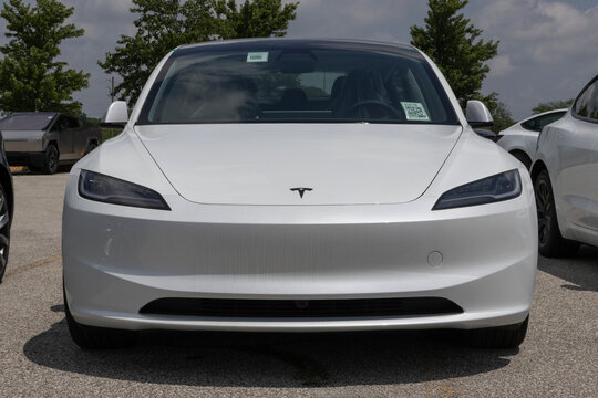 Tesla Model 3 Electric Sport Sedan at a dealership. Tesla offers the Model 3 with up to 321 miles driving range. MY:2026