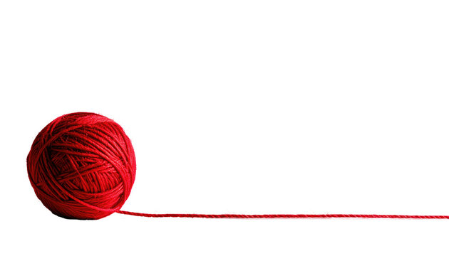 A vibrant red yarn ball rests against a stark black background, with a strand of thread extending from the ball