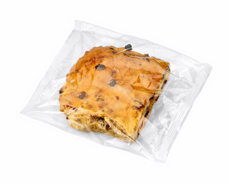 Currant bread with almond paste in plastic wrapper isolated on white