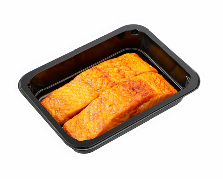 smoked salmon in a plastic tray isolated on white