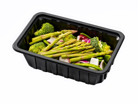 Broccoli asparagus onion in a plastic tray isolated on white