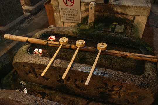 Traditional purification basin with wooden ladles at Japanese shrine