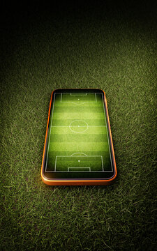 Mobile phone with soccer field screen on green grass lawn texture