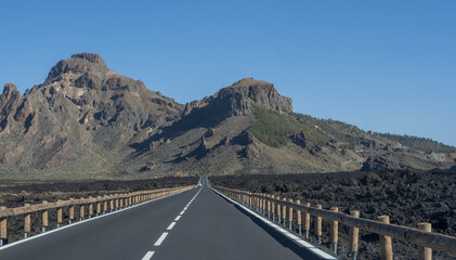 Well maintained road passing through spectacular volcanic scenery in Tenerife. Ideal image for travel, transportation and adventure tourism themes. © Olha