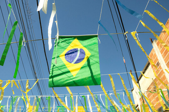 A street in Brazil decorated with Brazilian flags, ribbons, shirts, and World Cup paraphernalia. Rio de Janeiro, Brazil. City Of God