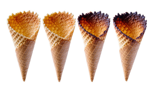 Isolated set of four waffle cones, some perfectly baked and others slightly burnt at the edge